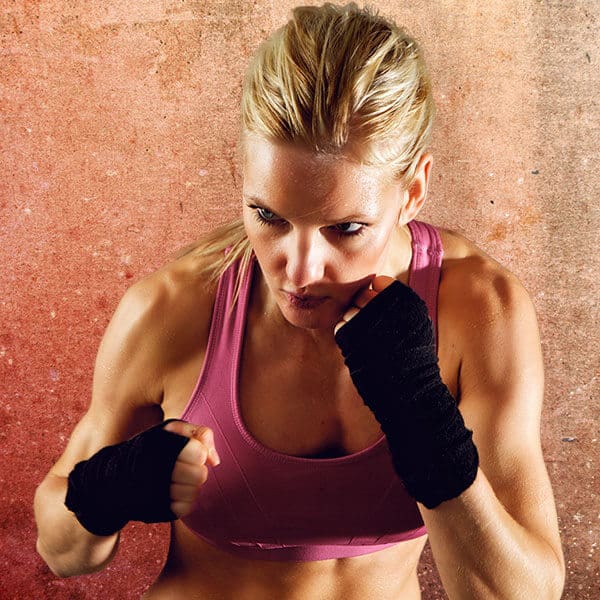Mixed Martial Arts Lessons for Adults in Rainier WA - Lady Kickboxing Focused Background