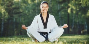 Martial Arts Lessons for Adults in Rainier WA - Happy Woman Meditated Sitting Background